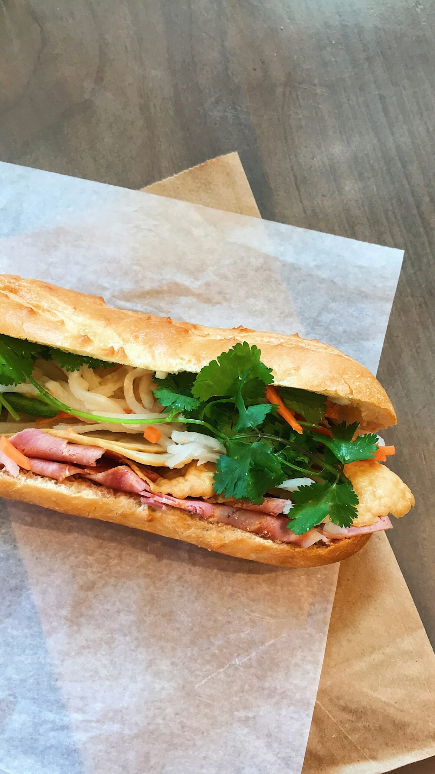 A bánh mì sandwich filled with herbs and vegetables