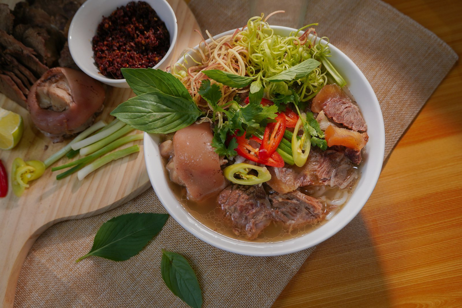 A bowl of Vietnamese noodle soup with fresh herbs