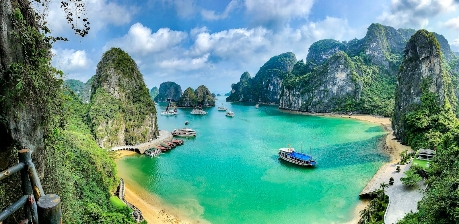 Boats on the turquoise water of Ha Long Bay among limestone islands