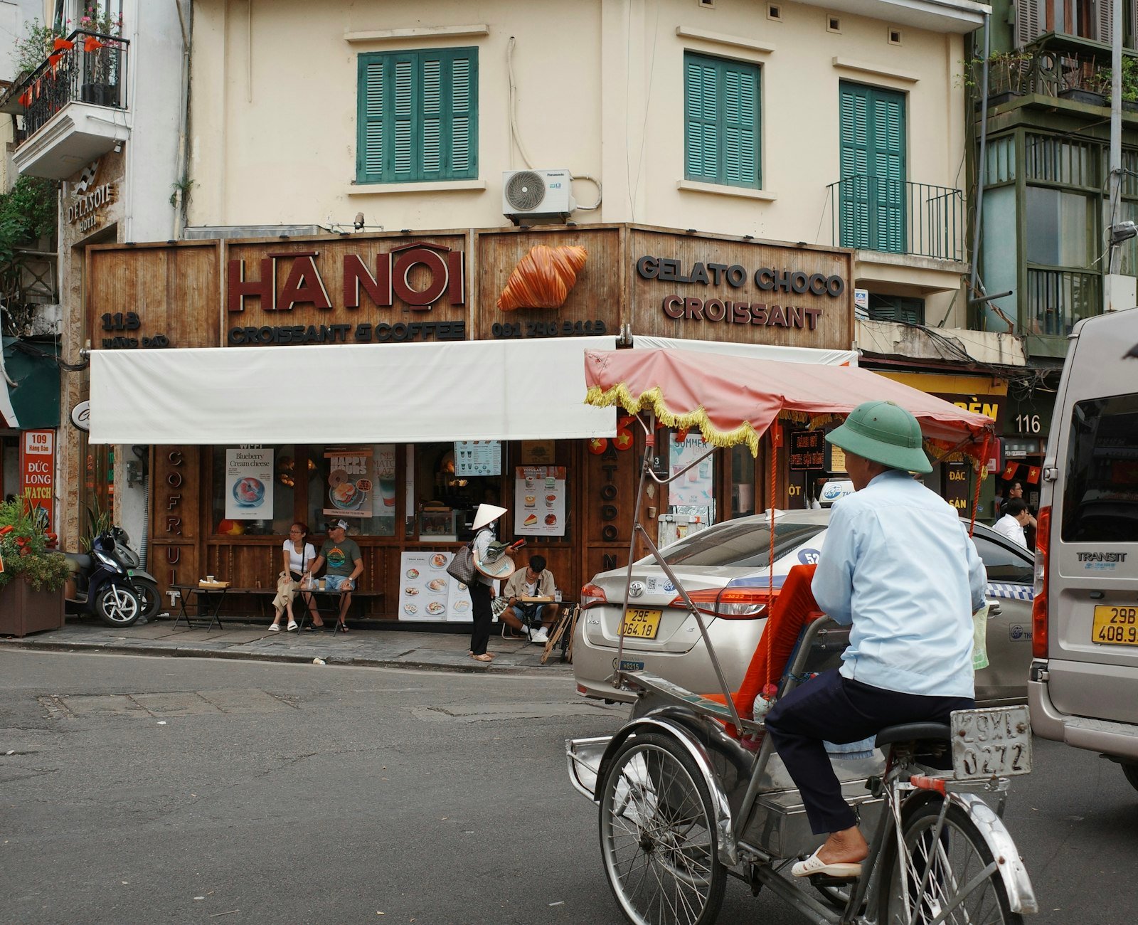 A Hanoi street scene with a cyclo driver