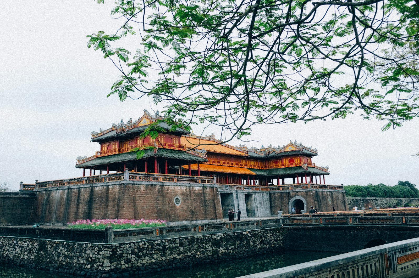 A historic building beside the water in Hue