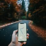A traveler holding a smartphone with a map