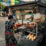 A woman standing at a street food cart in Vietnam
