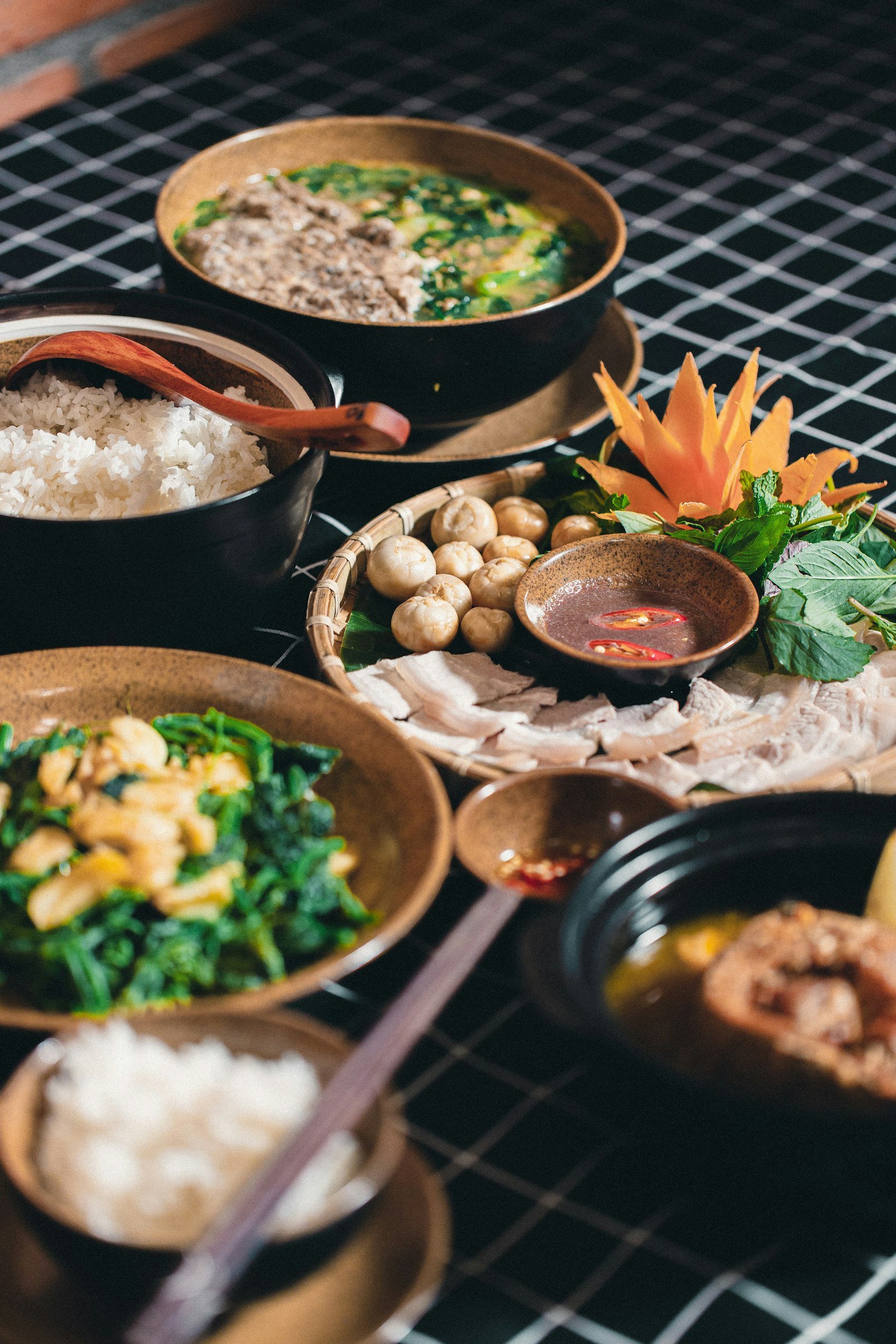 A table full of Vietnamese dishes shared family-style